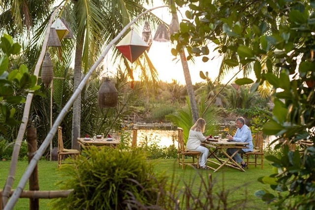 Two tourists enjoy a meal at the Field Restaurant in the suburban area of Hội An Town. The restaurant has been building the sustainable and responsible tourism standard. Photo courtesy of EMIC